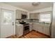 Updated kitchen featuring gray cabinets, stainless steel appliances and a stylish backsplash at 601 N Franklin St, Plant City, FL 33563