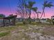 The spacious backyard features mature palm trees and a covered gazebo-style lounge area at 6268 39Th N Ave, St Petersburg, FL 33709