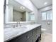 Modern bathroom featuring a double sink vanity with a marble countertop and a large mirror at 6268 39Th N Ave, St Petersburg, FL 33709
