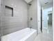 Updated bathroom featuring a tiled shower over tub with a built-in niche for toiletries at 6268 39Th N Ave, St Petersburg, FL 33709