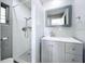 Clean and modern bathroom with a walk-in shower, gray vanity, and a large mirror providing ample lighting at 6268 39Th N Ave, St Petersburg, FL 33709