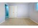 Simple room with neutral colored walls and terrazzo flooring with access to a closet and natural light from a window at 6268 39Th N Ave, St Petersburg, FL 33709