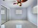 This bedroom features a ceiling fan, neutral walls, and a mirrored closet, providing a simple and functional space at 6268 39Th N Ave, St Petersburg, FL 33709