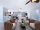 Staged living room featuring terrazzo flooring, neutral paint and tastefully appointed furniture with a view into the kitchen at 6268 39Th N Ave, St Petersburg, FL 33709