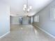 Bright, open living room with terrazzo floors, modern lighting, and large windows offering plenty of natural light at 6268 39Th N Ave, St Petersburg, FL 33709