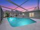 Inviting enclosed pool area featuring a refreshing pool and a clear view of the sky at dusk at 6268 39Th N Ave, St Petersburg, FL 33709