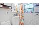 Charming bathroom with white subway tile, colorful shower curtain, and bright window at 6325 9Th S Ave, Gulfport, FL 33707