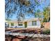 Charming one story home with a white exterior and a well manicured lawn at 6325 9Th S Ave, Gulfport, FL 33707