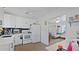 Well-lit kitchen with stainless steel appliances, white cabinets and a view into the living room at 6325 9Th S Ave, Gulfport, FL 33707