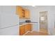 Efficient kitchen with wooden cabinetry, white appliances, and tiled backsplash at 6325 9Th S Ave, Gulfport, FL 33707
