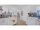 Bright kitchen with white cabinets, stainless steel appliances, and marble countertops at 6325 9Th S Ave, Gulfport, FL 33707