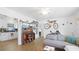 Cozy living room featuring stylish wood floors, a comfortable gray sofa, and unique wall decorations at 6325 9Th S Ave, Gulfport, FL 33707