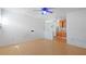Clean, open living space with wood floors, a ceiling fan, and a partial view into the kitchen at 6325 9Th S Ave, Gulfport, FL 33707