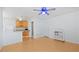 Bright living space with wood floors, partial kitchen view, and overhead ceiling fan at 6325 9Th S Ave, Gulfport, FL 33707