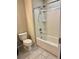 Cozy bathroom featuring a shower-tub combo and neutral-toned tiling at 6325 Yellow Buckeye Dr, Riverview, FL 33578