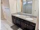 Bathroom featuring a double sink vanity and walk-in shower at 6325 Yellow Buckeye Dr, Riverview, FL 33578