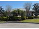 Exterior shot of community clubhouse with landscaping, mature trees and manicured shrubs at 6325 Yellow Buckeye Dr, Riverview, FL 33578