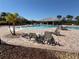 Community pool with lounge chairs, tables, lush landscaping, and a covered cabana at 6325 Yellow Buckeye Dr, Riverview, FL 33578