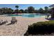 Community pool with lounge chairs, tables, lush landscaping, and umbrellas at 6325 Yellow Buckeye Dr, Riverview, FL 33578
