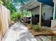 Backyard patio featuring stone pavers, outdoor seating, lush landscaping, and privacy fence at 6429 Gulfport Blvd. South Blvd, South Pasadena, FL 33707