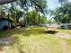 Backyard with lush green grass, landscaping, and outdoor furniture at 6429 Gulfport Blvd. South Blvd, South Pasadena, FL 33707