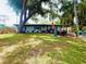 Beautiful backyard with large tree shading the home and an outdoor dining space at 6429 Gulfport Blvd. South Blvd, South Pasadena, FL 33707