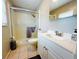 Bathroom featuring a shower with glass doors, white vanity, and neutral finishes at 6429 Gulfport Blvd. South Blvd, South Pasadena, FL 33707
