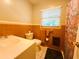 Bathroom featuring warm toned walls, tile walls, and neutral finishes at 6429 Gulfport Blvd. South Blvd, South Pasadena, FL 33707