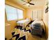Cozy bedroom with twin beds, ample natural light, and ceiling fan at 6429 Gulfport Blvd. South Blvd, South Pasadena, FL 33707