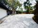 Spacious brick driveway leads to a charming home with colorful landscaping, a garage and a light blue front door at 6429 Gulfport Blvd. South Blvd, South Pasadena, FL 33707