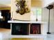 Unique fireplace with decorative art, set between kitchen and dining room, adds a charming focal point at 6429 Gulfport Blvd. South Blvd, South Pasadena, FL 33707