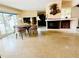 Bright living area showcasing a fireplace, tile floors and large windows, leading to a dining area at 6429 Gulfport Blvd. South Blvd, South Pasadena, FL 33707