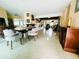 Open-concept living room and dining area featuring a cozy fireplace and neutral-toned furniture at 6429 Gulfport Blvd. South Blvd, South Pasadena, FL 33707