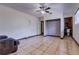 Bedroom with tile flooring, a ceiling fan, and an ensuite bathroom with tile at 7117 Wrenwood Cir, Tampa, FL 33617