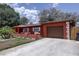 Charming one story home featuring an attached garage, and well manicured lawn at 7117 Wrenwood Cir, Tampa, FL 33617