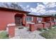 Eye-catching home featuring a vibrant exterior, landscaped garden, and covered entryway at 7117 Wrenwood Cir, Tampa, FL 33617