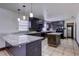Kitchen with dark cabinetry, granite countertops, tile backsplash, and stainless steel appliances at 7117 Wrenwood Cir, Tampa, FL 33617
