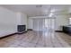 Living room with fireplace, tile floors, and sliding doors leading to outdoor space at 7117 Wrenwood Cir, Tampa, FL 33617