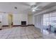 Open-concept living area featuring tile floors, fireplace, and abundant natural light at 7117 Wrenwood Cir, Tampa, FL 33617