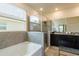 Elegant bathroom featuring a soaking tub, glass shower, and dual vanities at 7154 Steer Blade Dr, Zephyrhills, FL 33541