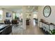 Open-concept living space with elegant tile flooring, recessed lighting, and stylish furnishings at 7154 Steer Blade Dr, Zephyrhills, FL 33541
