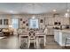 Bright dining room features luxury vinyl floors, pendant lighting and is adjacent to the kitchen at 7423 Sungold Meadow Ct, Apollo Beach, FL 33572