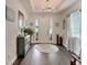 Inviting foyer with hardwood floors, white door, chandelier, and decor throughout at 7423 Sungold Meadow Ct, Apollo Beach, FL 33572