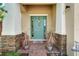 Beautiful front door with brick pillars, a wreath, and lovely potted plants on a brick porch at 7423 Sungold Meadow Ct, Apollo Beach, FL 33572