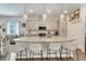 Stylish kitchen with island, stainless steel appliances, light countertops, and hanging pendant lights at 7423 Sungold Meadow Ct, Apollo Beach, FL 33572