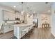 Modern kitchen with granite countertops, stainless steel appliances, and an eat-in island at 7423 Sungold Meadow Ct, Apollo Beach, FL 33572