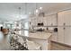 Modern kitchen with granite countertop, stainless steel appliances, hanging lights, and bar stool seating at 7423 Sungold Meadow Ct, Apollo Beach, FL 33572