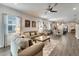 Inviting living room that flows into the dining area and kitchen creating a warm and welcoming atmosphere at 7423 Sungold Meadow Ct, Apollo Beach, FL 33572