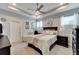 Serene main bedroom boasting a tray ceiling, plush bedding and ample natural light at 7423 Sungold Meadow Ct, Apollo Beach, FL 33572