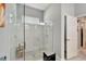 Beautiful shower with tiled walls and floor, a bench, and a glass surround at 7423 Sungold Meadow Ct, Apollo Beach, FL 33572